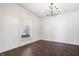 Bright and airy living room with hardwood floors and a large window, ready to be furnished at 2748 Carrollton Ave, Indianapolis, IN 46205