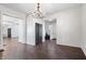 Expansive living room with dark wood floors and bright white walls, awaiting your personal touch at 2748 Carrollton Ave, Indianapolis, IN 46205