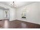 Spacious living room with dark wood floors and large windows, ready for personalization at 2748 Carrollton Ave, Indianapolis, IN 46205