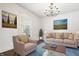 Bright living room featuring neutral decor, artwork, and a cozy seating arrangement at 2748 Carrollton Ave, Indianapolis, IN 46205