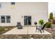 Backyard patio area featuring outdoor furniture and well-manicured lawn and landscaping at 305 Beacon Point Ln, Fortville, IN 46040