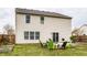 Backyard featuring patio and lawn surrounded by mature trees and fenced yard at 305 Beacon Point Ln, Fortville, IN 46040