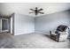 Spacious bedroom features gray carpet, chair, ceiling fan and neutral paint at 305 Beacon Point Ln, Fortville, IN 46040