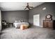 Spacious bedroom features gray carpet, ceiling fan, neutral paint, a bed and dresser at 305 Beacon Point Ln, Fortville, IN 46040
