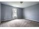 This bedroom has a large window allowing for natural light and neutral walls at 305 Beacon Point Ln, Fortville, IN 46040