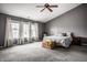 Bright bedroom showcasing a vaulted ceiling, neutral decor, and large windows at 305 Beacon Point Ln, Fortville, IN 46040