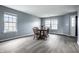Dining room with hardwood floors, a wooden table and chairs, and abundant natural light at 305 Beacon Point Ln, Fortville, IN 46040