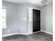 Entryway featuring modern gray walls, wood-look floors, and a classic black front door at 305 Beacon Point Ln, Fortville, IN 46040
