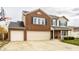 Two-story brick home featuring an attached two-car garage, basketball hoop, and manicured front lawn at 305 Beacon Point Ln, Fortville, IN 46040