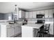 Updated kitchen with stainless steel appliances, light gray cabinets, and quartz countertops at 305 Beacon Point Ln, Fortville, IN 46040