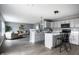 Modern kitchen featuring gray cabinetry, a breakfast bar, and an open concept design at 305 Beacon Point Ln, Fortville, IN 46040