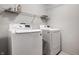 Laundry room features LG washer and dryer and metal shelving, perfect for laundry day at 305 Beacon Point Ln, Fortville, IN 46040