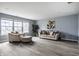 Bright living room boasting hardwood floors, neutral furnishings, and plenty of natural light at 305 Beacon Point Ln, Fortville, IN 46040