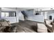 Spacious living room offers hardwood floors, cozy seating, and views into the kitchen and staircase at 305 Beacon Point Ln, Fortville, IN 46040