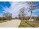 Scenic view of Memorial Park with a paved path, an American flag, and mature trees under a partly cloudy sky at 305 Beacon Point Ln, Fortville, IN 46040