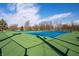 Well-maintained tennis courts on a sunny day, surrounded by greenery, offering a recreational amenity at 305 Beacon Point Ln, Fortville, IN 46040