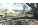Backyard view of the property featuring grass, trees, and a detached garage at 318 Chester St, Anderson, IN 46012