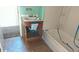 Bathroom with a single sink vanity, tile flooring, tub, and small storage at 318 Chester St, Anderson, IN 46012