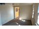 Empty living room with neutral walls, carpet, and doorway view to the kitchen at 318 Chester St, Anderson, IN 46012