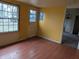 This sunroom has wood flooring, a window, and a doorway that leads to another room at 318 Chester St, Anderson, IN 46012