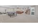 Large finished basement featuring a ping pong table, seating, and a home theater at 3240 Wildlife Trl, Zionsville, IN 46077
