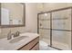 Bright bathroom featuring a shower with glass doors, modern sink, and neutral color palette at 3240 Wildlife Trl, Zionsville, IN 46077