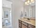 Neutral toned bathroom featuring a single sink vanity, ample lighting, and tiled flooring at 3240 Wildlife Trl, Zionsville, IN 46077