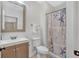 Bright bathroom with decorative shower curtain, vanity, and sink at 3240 Wildlife Trl, Zionsville, IN 46077