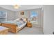 Bright bedroom with wooden bed frame, coordinating side tables and neutral gray carpeting at 3240 Wildlife Trl, Zionsville, IN 46077