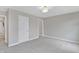 Bedroom with neutral walls, neutral carpeting, and a white door to the ensuite at 3240 Wildlife Trl, Zionsville, IN 46077