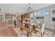Open-concept dining area featuring hardwood floors, modern lighting, and an adjacent kitchen at 3240 Wildlife Trl, Zionsville, IN 46077
