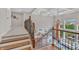 Staircase offers views of the dining area and a spacious living room with fireplace at 3240 Wildlife Trl, Zionsville, IN 46077