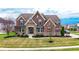 Charming two-story brick home with stone accents, manicured lawn, and well-maintained landscaping at 3240 Wildlife Trl, Zionsville, IN 46077