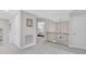 Upstairs hallway featuring neutral carpet, paint, and railing with dark wooden detail at 3240 Wildlife Trl, Zionsville, IN 46077