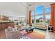 Open-concept living room with high ceilings, large windows, and modern furniture and decor at 3240 Wildlife Trl, Zionsville, IN 46077