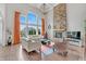 Spacious living room featuring a stone fireplace, large windows, high ceilings, and modern furniture at 3240 Wildlife Trl, Zionsville, IN 46077