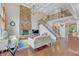 Bright living room with stone fireplace, hardwood floors, and open staircase at 3240 Wildlife Trl, Zionsville, IN 46077