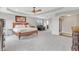 Expansive bedroom boasts a sitting area, tray ceiling, and beautiful furnishings at 3240 Wildlife Trl, Zionsville, IN 46077
