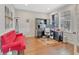 Bright home office with hardwood floors, a red sofa, a large desk, and natural light at 3240 Wildlife Trl, Zionsville, IN 46077