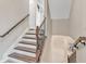 A staircase with wooden steps and decorative black metal spindles at 3240 Wildlife Trl, Zionsville, IN 46077