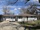Classic single-story home with white siding, inviting driveway, and mature trees providing shade and curb appeal at 3314 Argyle Ct, Indianapolis, IN 46226