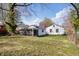 Spacious backyard with a view of the rear of the home, as well as a detached screened patio at 3445 N Olney St, Indianapolis, IN 46218