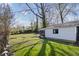 Expansive backyard with mature trees and a detached, screened patio at 3445 N Olney St, Indianapolis, IN 46218