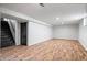 Spacious basement features hardwood floors, white walls, stairs, and a door at 3445 N Olney St, Indianapolis, IN 46218