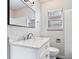 Bathroom featuring marble vanity, white tiled walls, toilet, window, and a modern mirror at 3445 N Olney St, Indianapolis, IN 46218