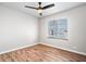 Empty bedroom features hardwood floors, one window, neutral walls, and a ceiling fan at 3445 N Olney St, Indianapolis, IN 46218