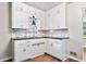 Functional kitchen features white cabinets, dark countertops, stylish backsplash, and modern faucet fixtures at 3445 N Olney St, Indianapolis, IN 46218