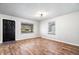 Well-lit living room features hardwood floors, large windows, and ample space for versatile use at 3445 N Olney St, Indianapolis, IN 46218