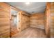 Bedroom featuring wood-paneled walls, light-colored floor, shelving, and an adjacent room at 3721 S 575 W, Trafalgar, IN 46181