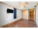 Bedroom with wood laminate flooring, natural wood trim and ceiling fan at 3721 S 575 W, Trafalgar, IN 46181